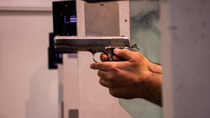 male hands holding a pistol