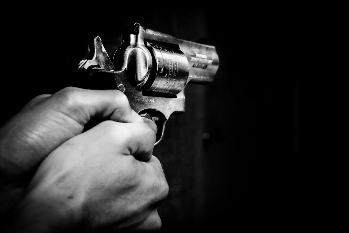 a person holding a revolver