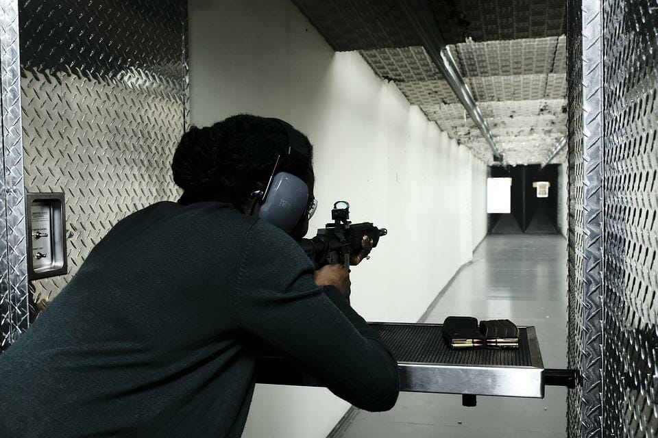 a woman shooting on a gun range