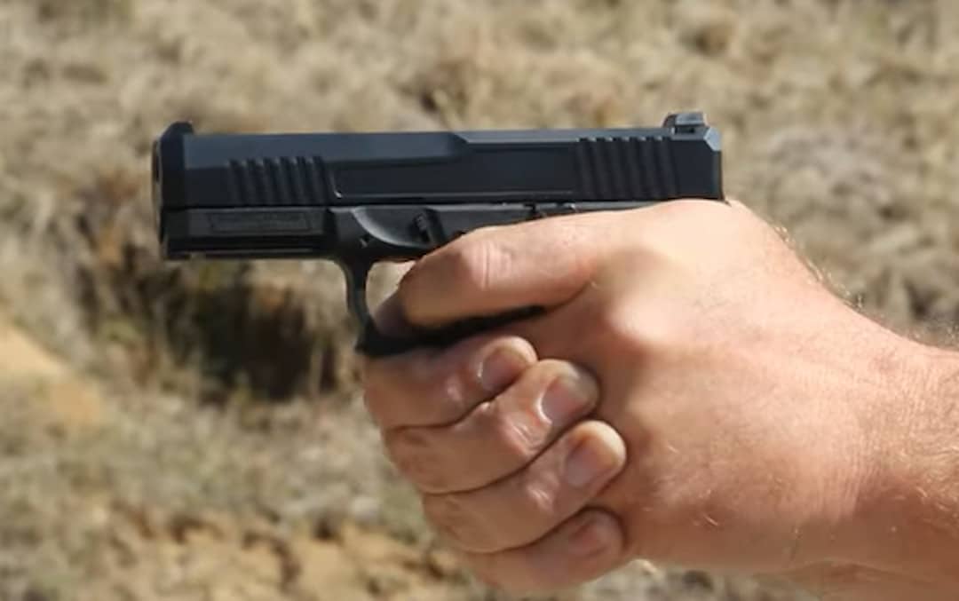 a gun in the person's hands