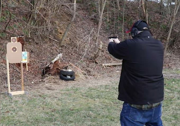 a person shooting on the range