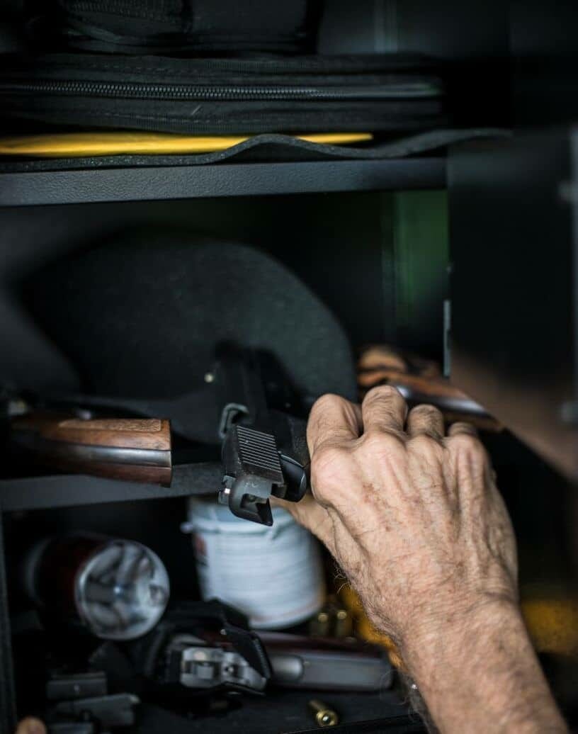 a person taking the gun from the storage