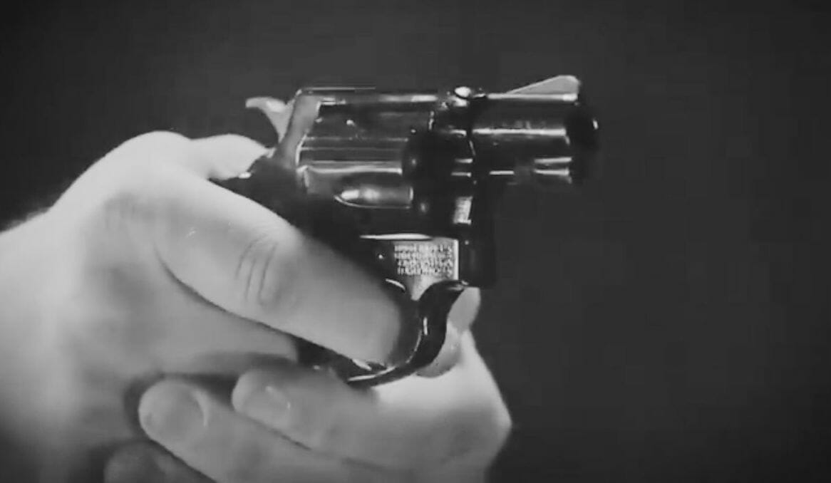 A person holding a revolver
