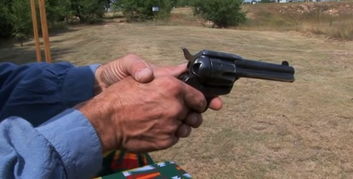 A person holding a revolver