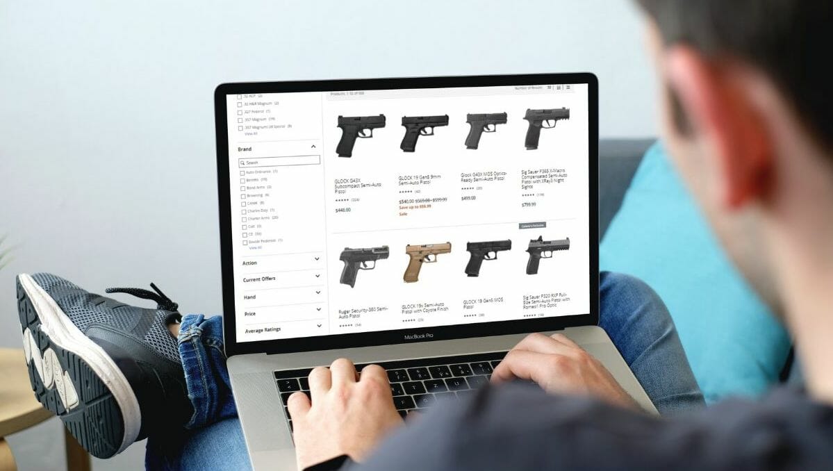 A person researching an online handgun store on their laptop